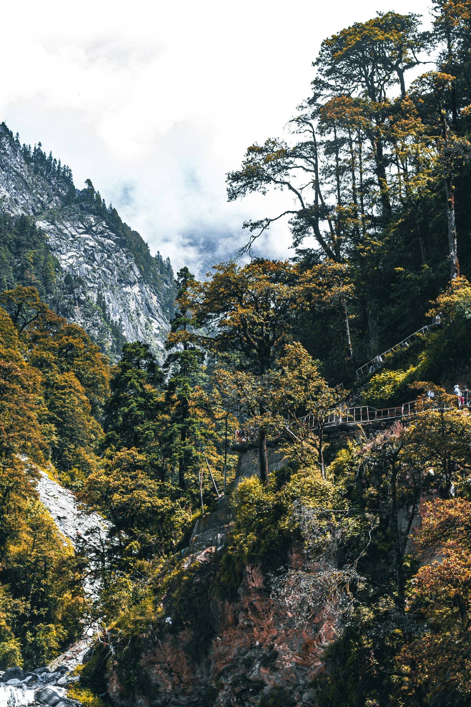 a scenic view of a mountain with a bridge in the middle